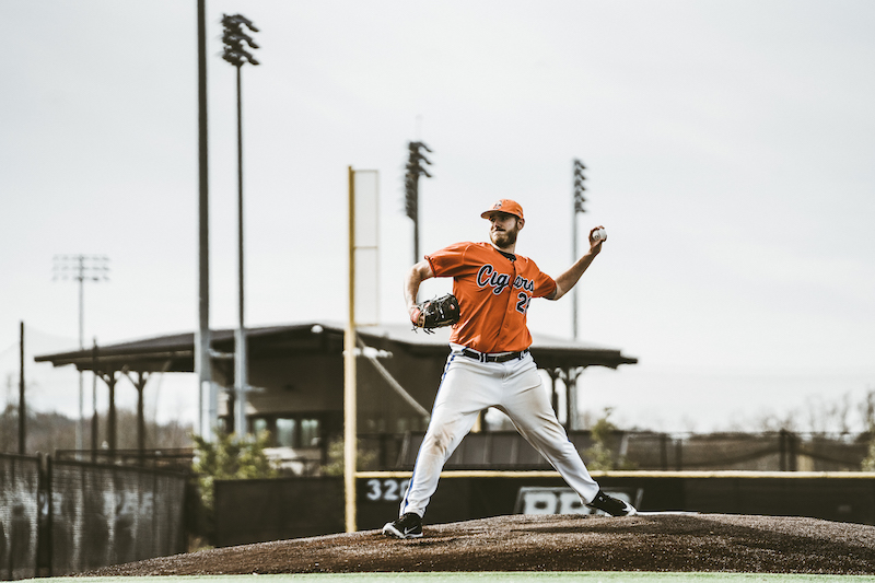 Cigars pitcher #2 in mid-delivery on the mound